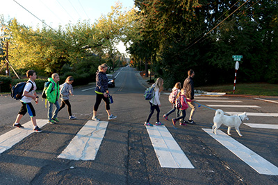 A family walks across the street