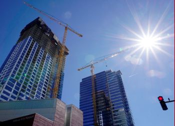 image of downtown skyline with construction cranes