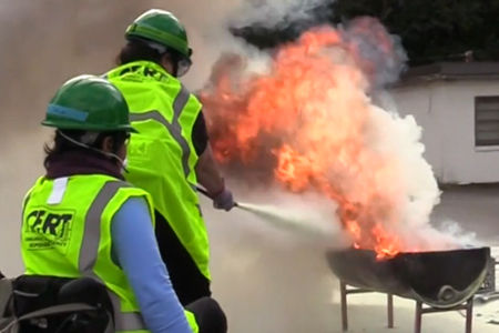 A person in a wheel chair and CERT gear in a fire drill