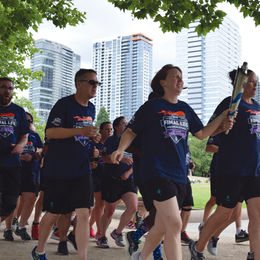 Smiling people running at the Special Olympics torch run