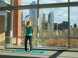 image of woman standing on yoga mat